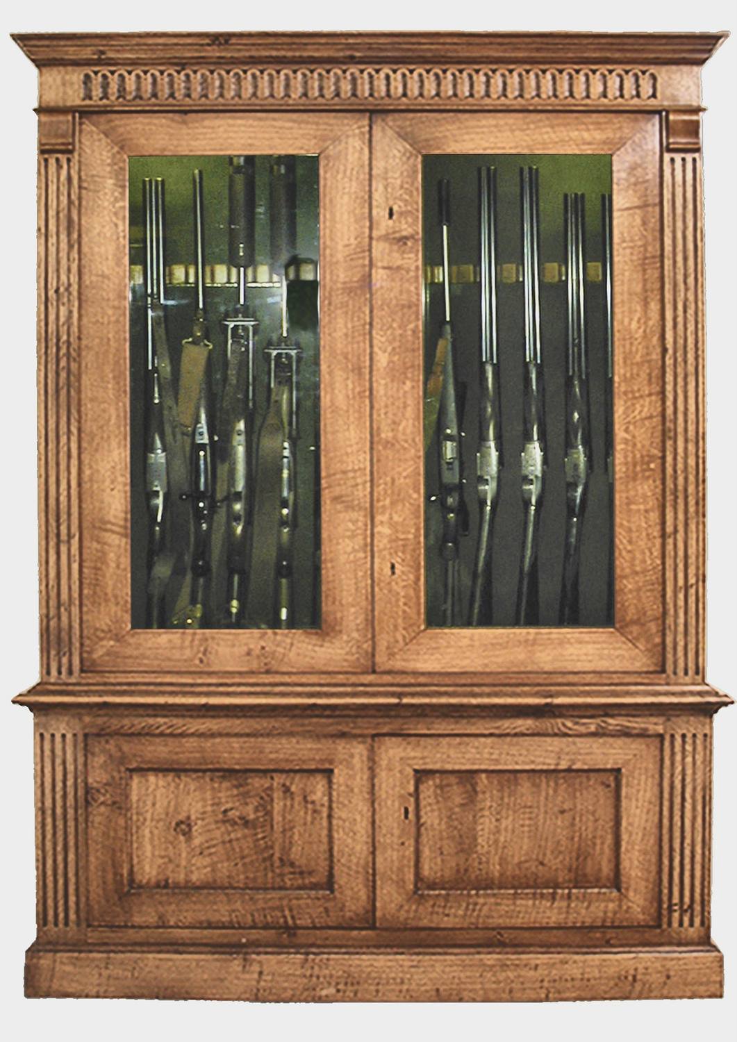 Bespoke gun cabinets in oak, glazed, with a hand-carved cornice