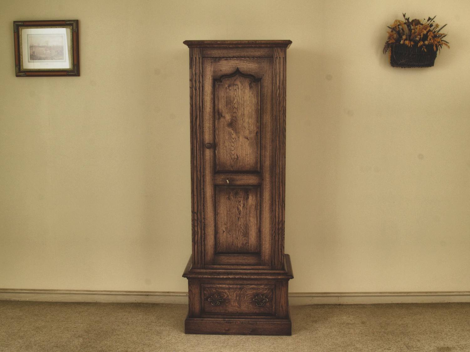 Solid timber gun cabinets: an arched panelled door, closed, giving nothing away