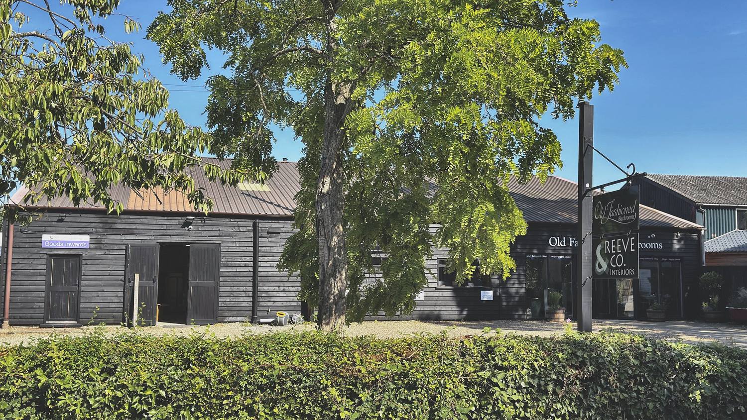 Black weatherboarded workshop buildings at Mickfield, Suffolk