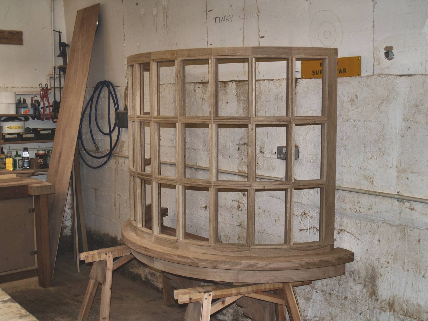 A gun room commission in the workshop: a curved glazed frame under construction in Suffolk